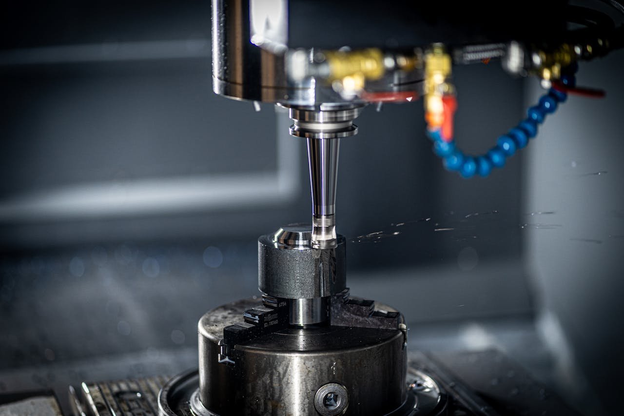 our-services-1 Close-up of CNC machine in action, showcasing precision engineering and industrial equipment.